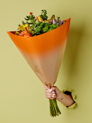 Elm Sleeve in Orange, lifestyle image with flowers