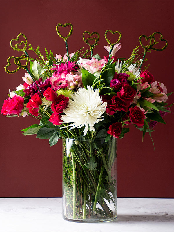 Several Heart Moss Picks in a vase bouquet