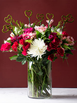 Several Heart Moss Picks in a vase bouquet