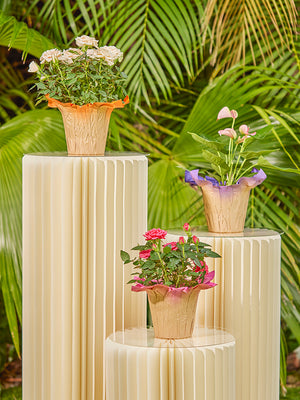 Vista Kraft Pot Cover lifestyle image shown in orange, purple and pink