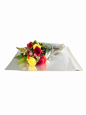 Wrap EZ, wrapped with flowers, sitting on top of more Wrap EZ Sheets (not wrapped)