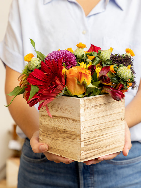 Florist holding wooden square container